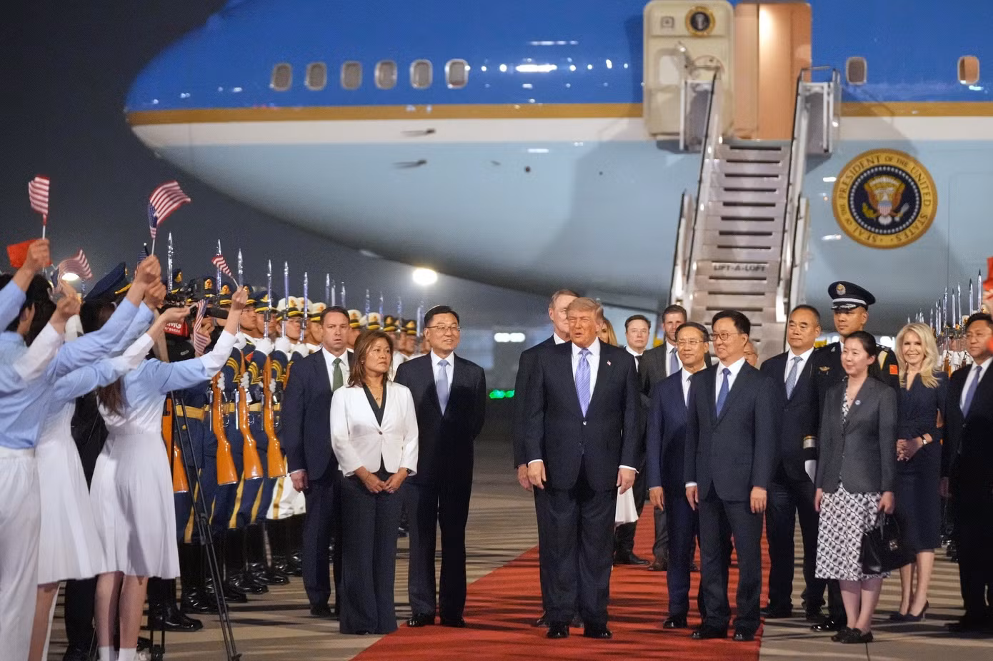 Tổng thống Trump cũng được chào đón bởi 300 thanh niên Trung Quốc trong bộ đồng phục xanh trắng, đứng dọc đường băng, cùng đội danh dự quân đội và ban nhạc quân đội. (Ảnh: AP)