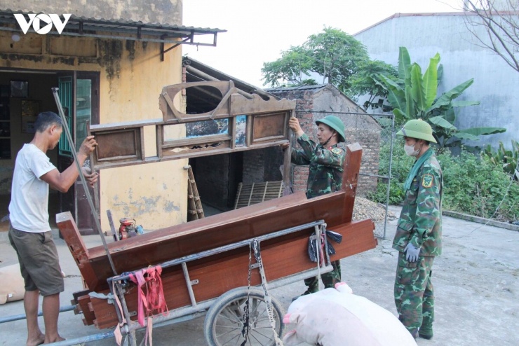 Chiến sĩ Trung đoàn 833 giúp người dân dọn dẹp đồ đạc để bàn giao đất ở.