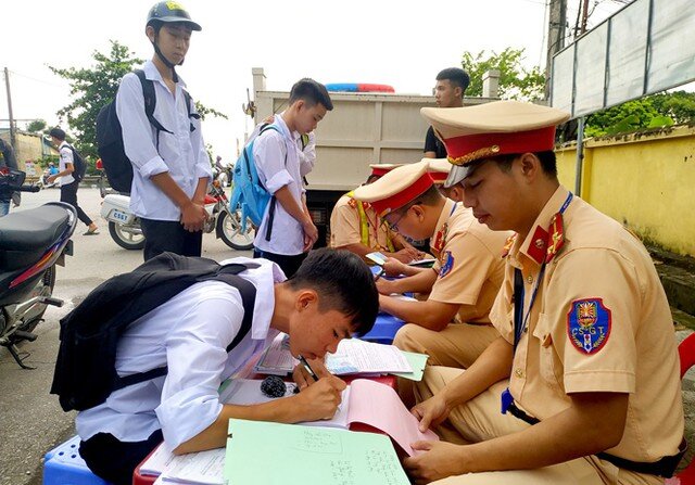 Lực lượng cảnh sát giao thông kiểm tra, xử lý học sinh vi phạm trật tự ATGT. Ảnh: VGP