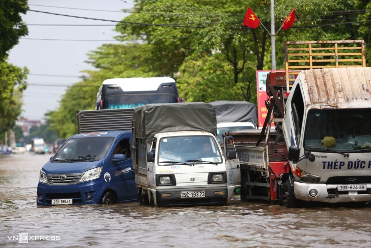 Ngập sâu trên quãng đường dài nên hàng loạt ôtô tải chết máy, phải nằm chờ cứu hộ. Xe con hầu hết không dám vượt qua đoạn đường này, phải xoay xở đi vòng xa hơn theo lối đại lộ Thăng Long.