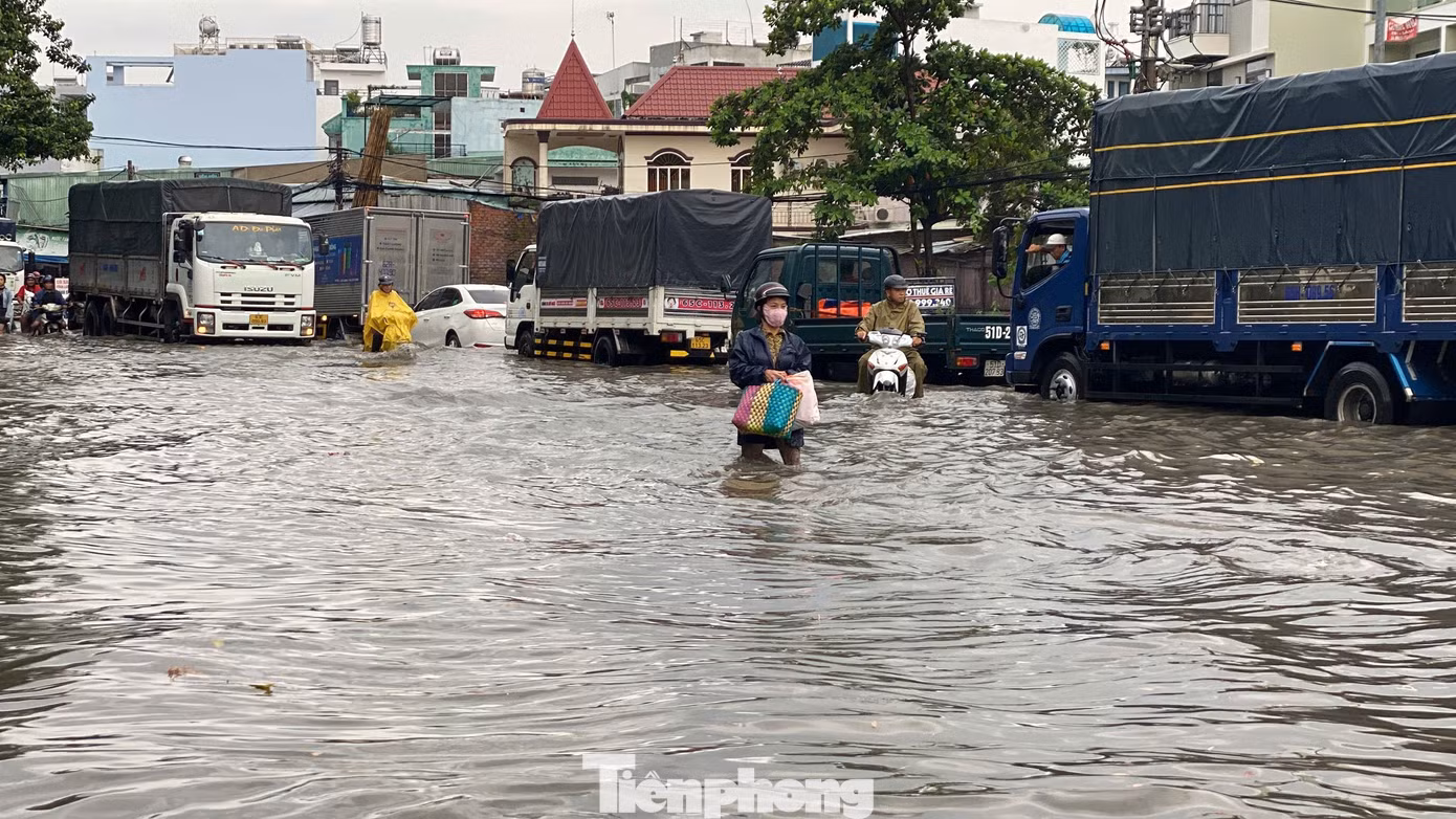 Người dân bì bõm vượt qua điểm ngập sâu trên đường Hồ Học Lãm.
