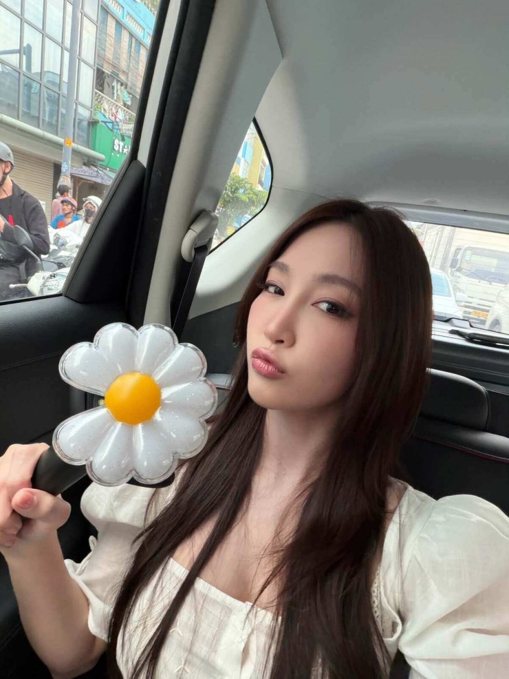 Ca sĩ Juky San mang theo lightstick hoa cúc khuyết cánh ra sân. Cô gọi chuyến "đu concert" này là "đi đón người thân bên Hàn về". Ảnh: Facebook Juky San